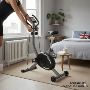 A compact folding exercise bike positioned next to a small wooden desk in a multifunctional UK bedroom-office.