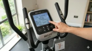 A user adjusting the resistance settings on a cross trainer console to maintain a safe, low-impact intensity for knee rehabilitation.