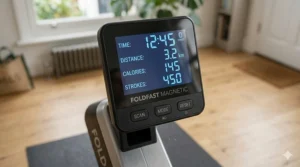 A photorealistic close-up illustration of the digital LCD console on a FOLDFAST MAGNETIC rower, displaying active workout metrics and control buttons.