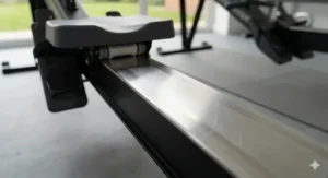 A high-detail shot of a textured aluminium monorail and seat rollers, emphasizing the build quality and durability of mid-range Concept2 alternatives.