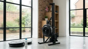 An air rowing machine stored vertically in a British home gym to save floor space when not in use.