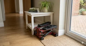 A small mini stepper tucked neatly under a side table in a British flat, highlighting its space-saving design for smaller homes.