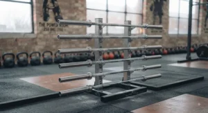 Well-equipped weightlifting platform area featuring multiple Olympic barbells in a British gym.