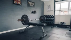 Space-saving home gym layout featuring an adjustable bench and an EZ curl bar.